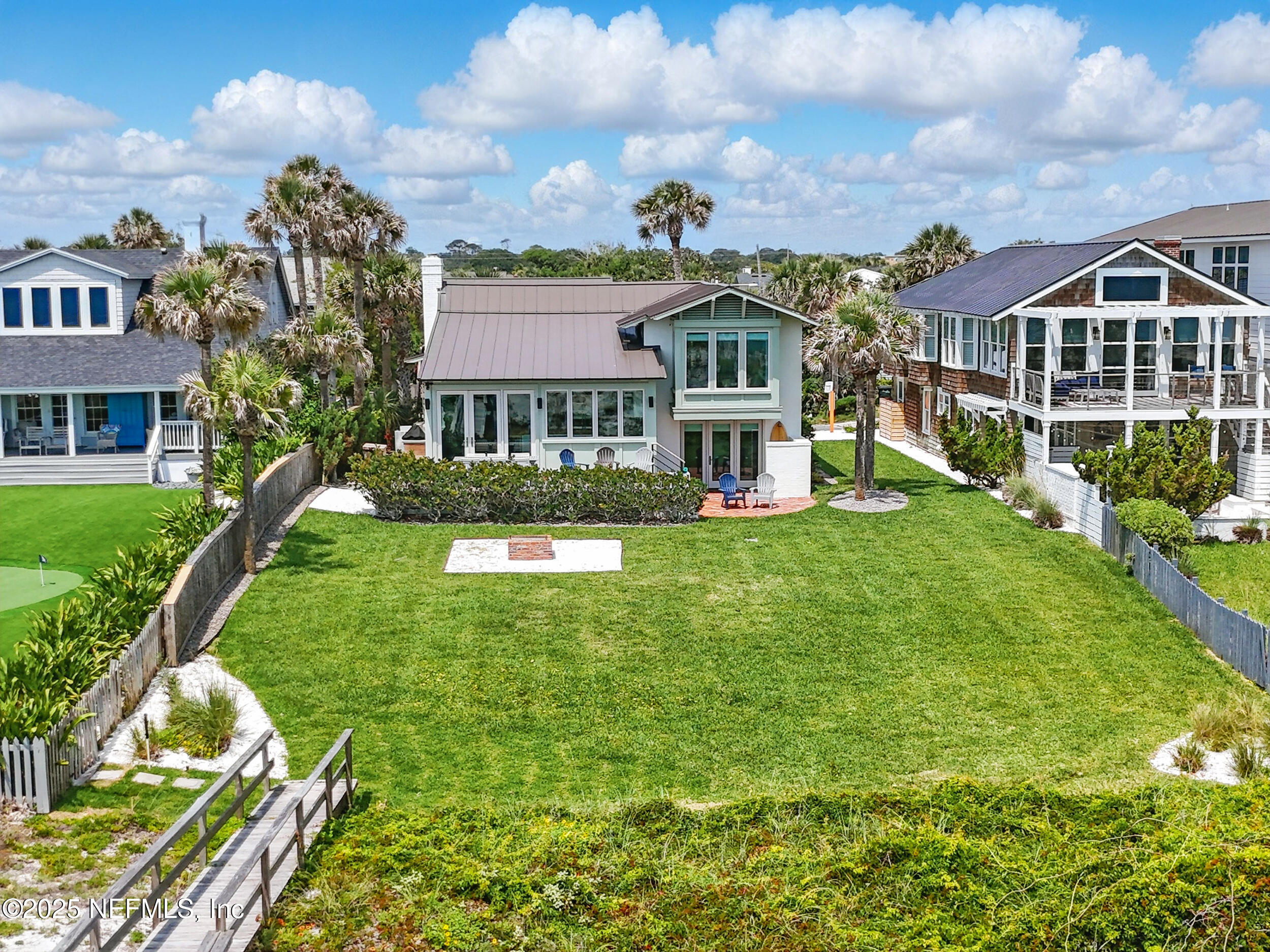 816 Ocean Front Neptune Beach, FL 32266 - Photo 5 of 65 a front view of a residential apartment building with a yard