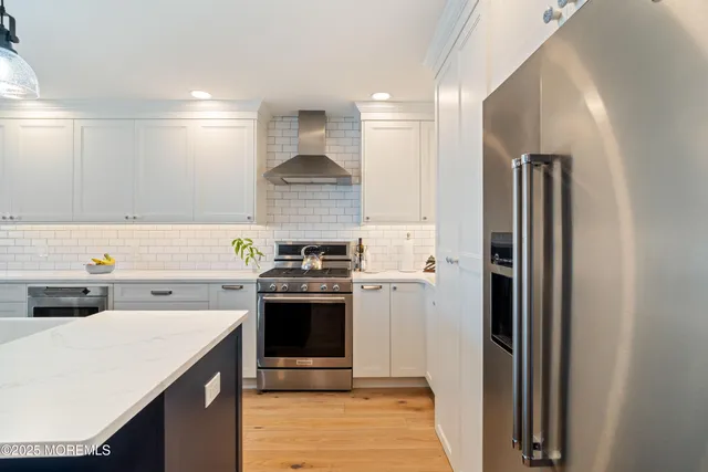 a kitchen with a stove and a refrigerator