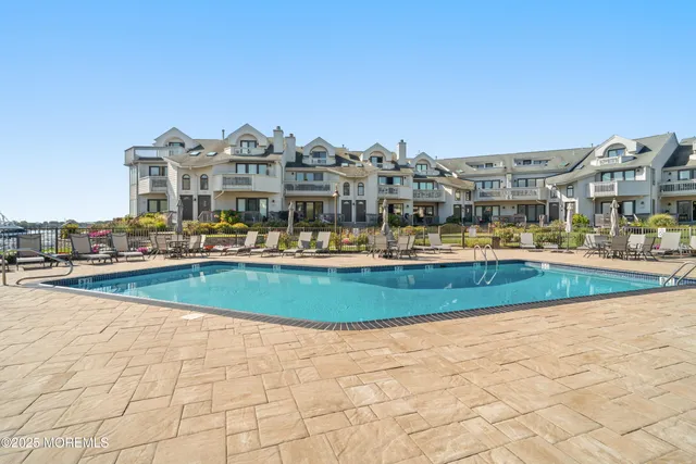 a view of residential houses with outdoor space and lakeside