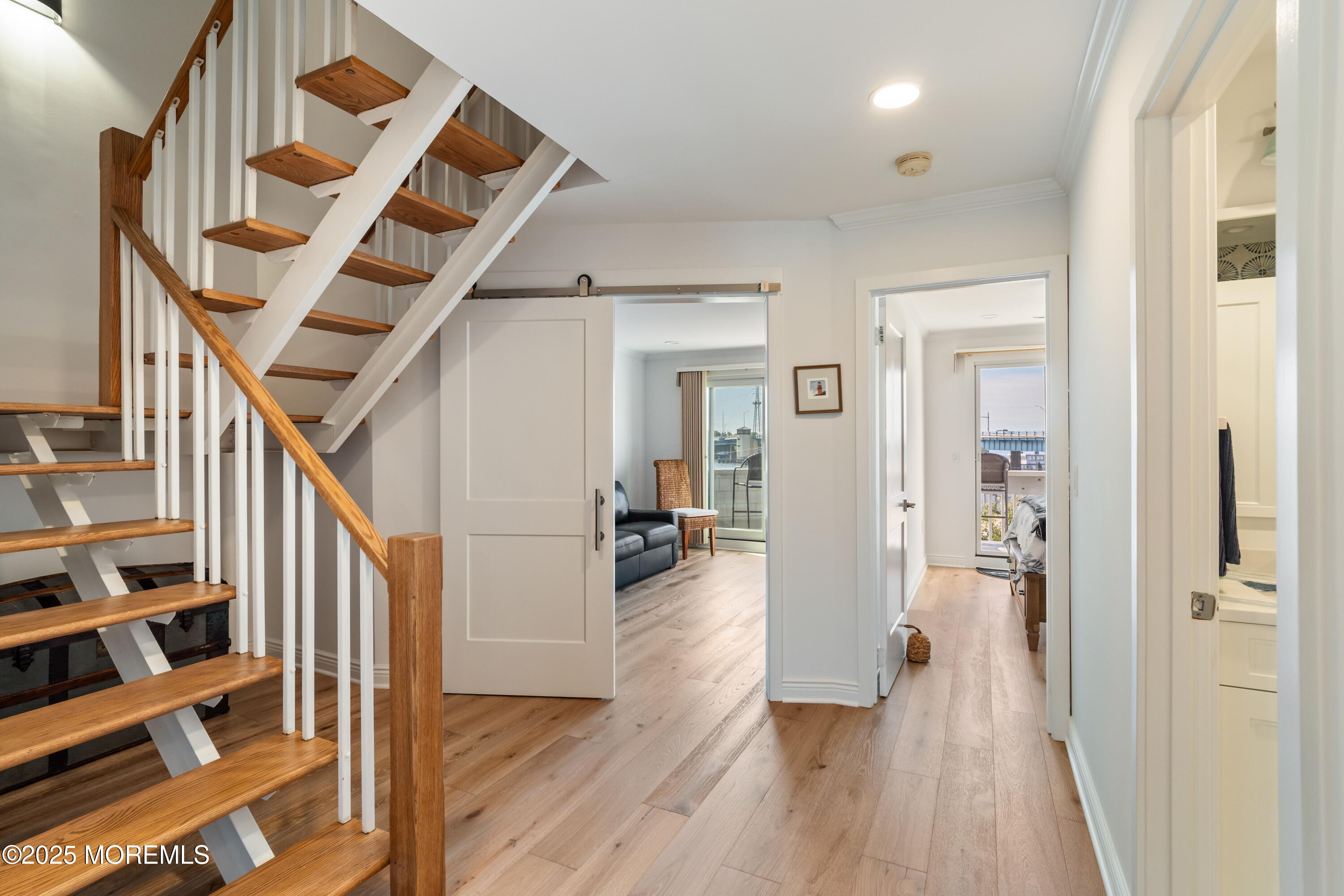 118 Ashley Avenue Brielle, NJ 08730 - Photo 20 of 34 a view of hallway with wooden floor and stairs