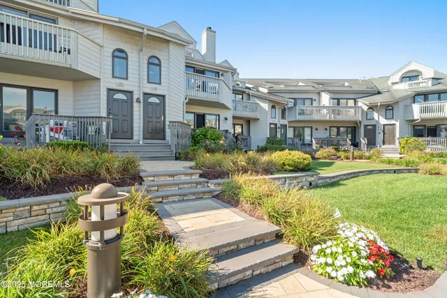 a front view of a house with swimming pool and outdoor seating