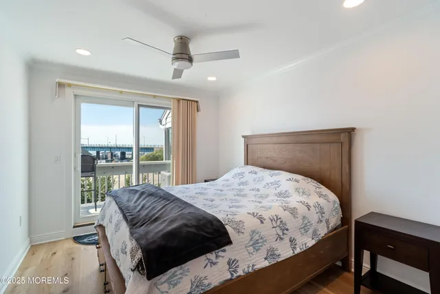 a bedroom with a bed a table and a window