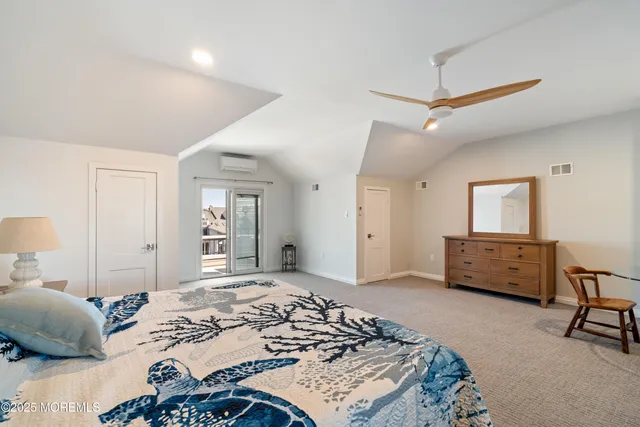 a bedroom with a bed a dresser and a window