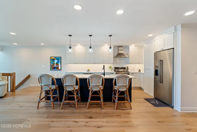a large kitchen with a dining table chairs and refrigerator