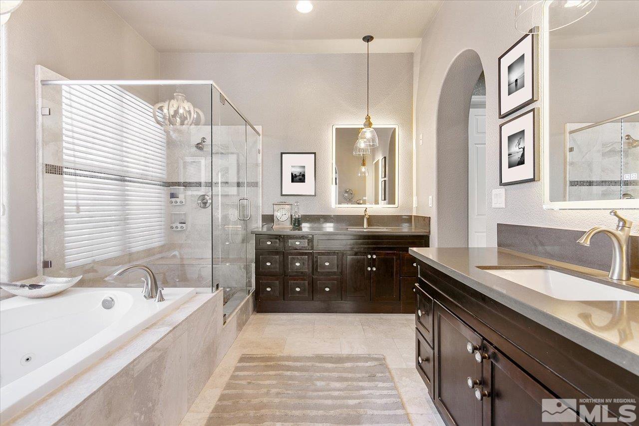 2956 Flint Ridge Court Reno, NV 89511 - Photo 23 of 40 a spacious bathroom with a granite countertop sink a bathtub and a shower