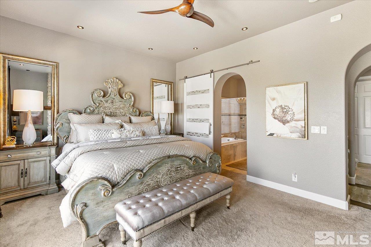 2956 Flint Ridge Court Reno, NV 89511 - Photo 36 of 40 a bedroom with a bed and a chandelier