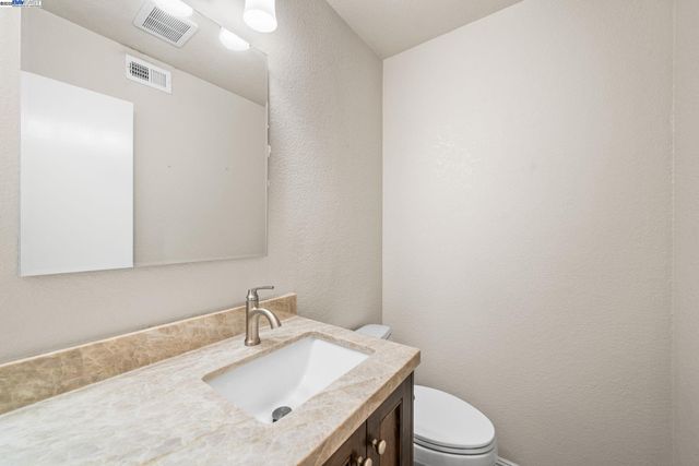 a bathroom with a sink a toilet and mirror