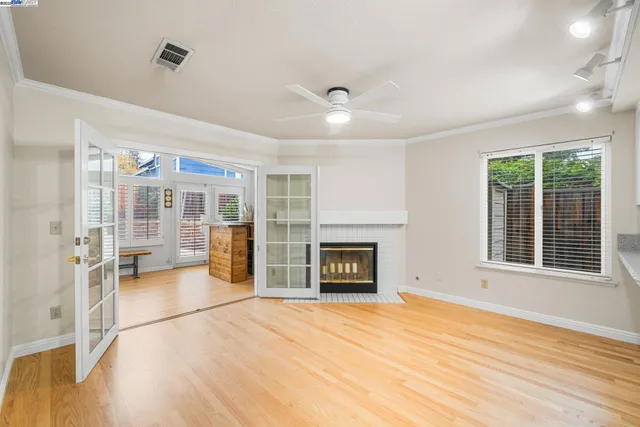 a view of a livingroom with wooden floor and a fireplace