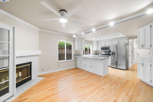 a large kitchen with cabinets and stainless steel appliances