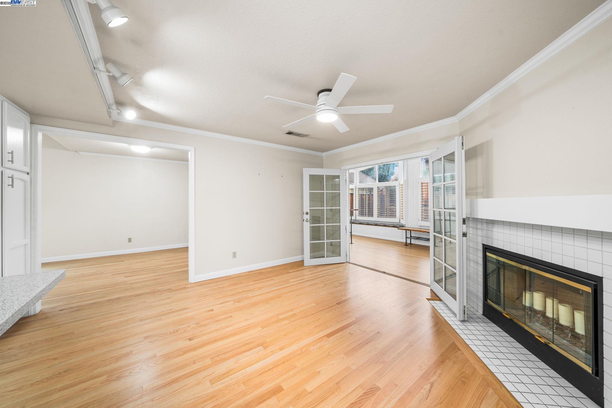 2864 El Capitan Drive Pleasanton, CA 94566 - Photo 16 of 45 a view of an empty room with a fireplace and a ceiling fan