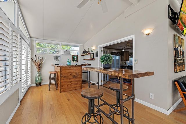 a dining room with furniture and wooden floor