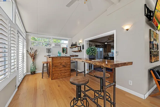 a dining room with furniture and wooden floor