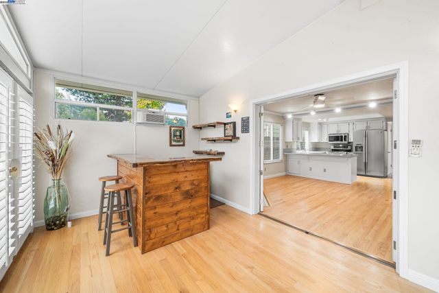 a view of kitchen with furniture and wooden floor