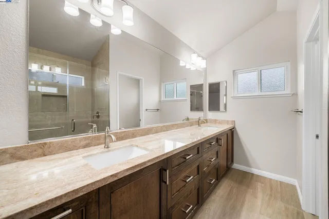 a bathroom with a granite countertop sink a large mirror and vanity