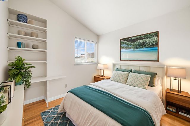 a bedroom with a bed and a potted plant