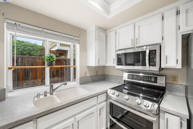 a kitchen with a sink and a stove top oven