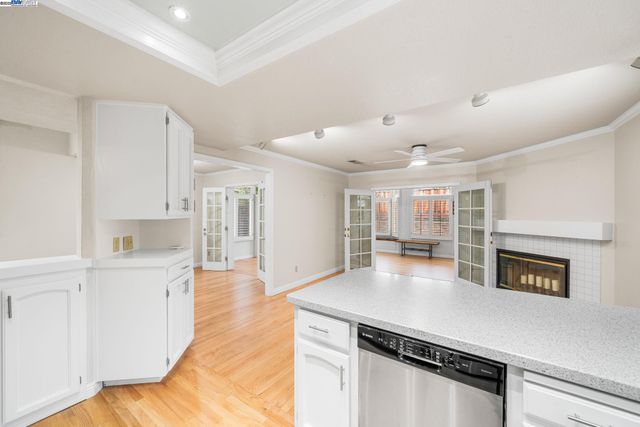 a open kitchen with cabinets a sink and wooden floor