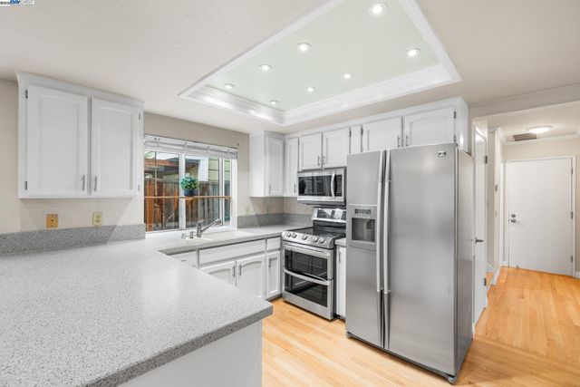a kitchen with stainless steel appliances a refrigerator sink and stove