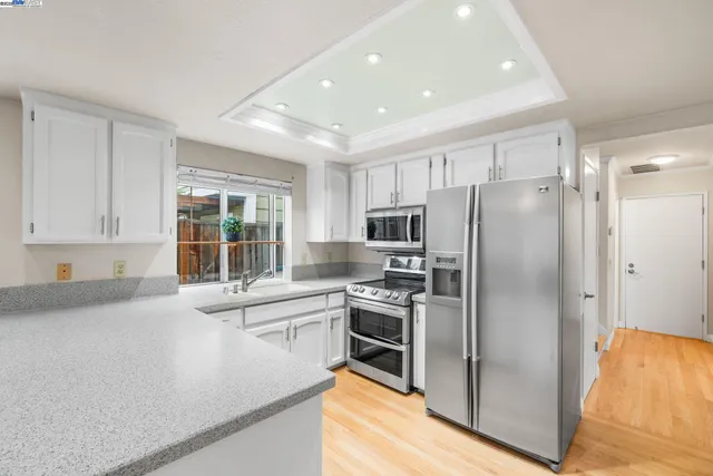 a kitchen with stainless steel appliances a refrigerator sink and stove