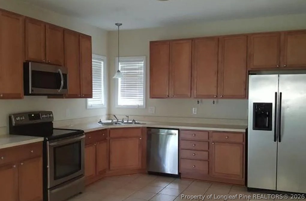 8721 Looking Glass Road Linden, NC 28356 - Photo 6 of 25 a kitchen with stainless steel appliances granite countertop a stove a sink dishwasher and a microwave oven with cabinets