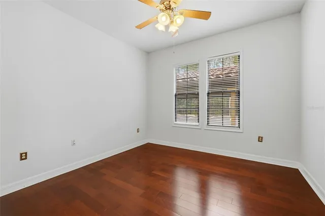 a kitchen with granite countertop cabinets appliances and a wooden floor