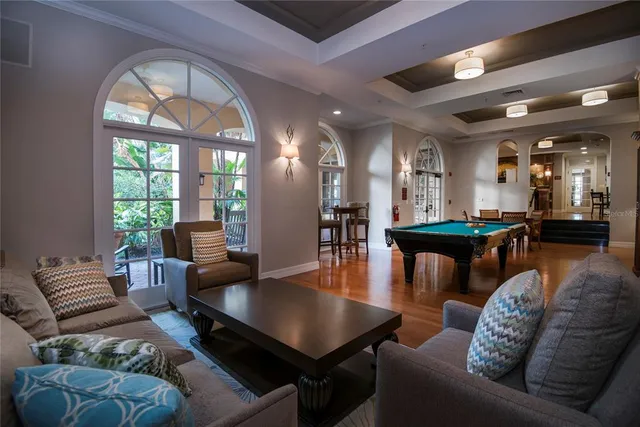 an aerial view of a house with swimming pool a yard and a fountain