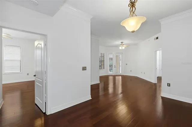 a view of an empty room with wooden floor