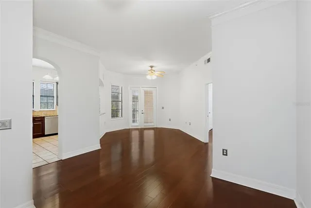 a view of a livingroom with wooden floor and a ceiling fan
