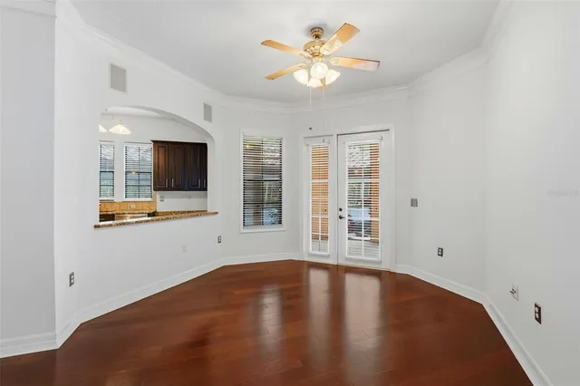a kitchen with granite countertop wooden cabinets a refrigerator stove and sink
