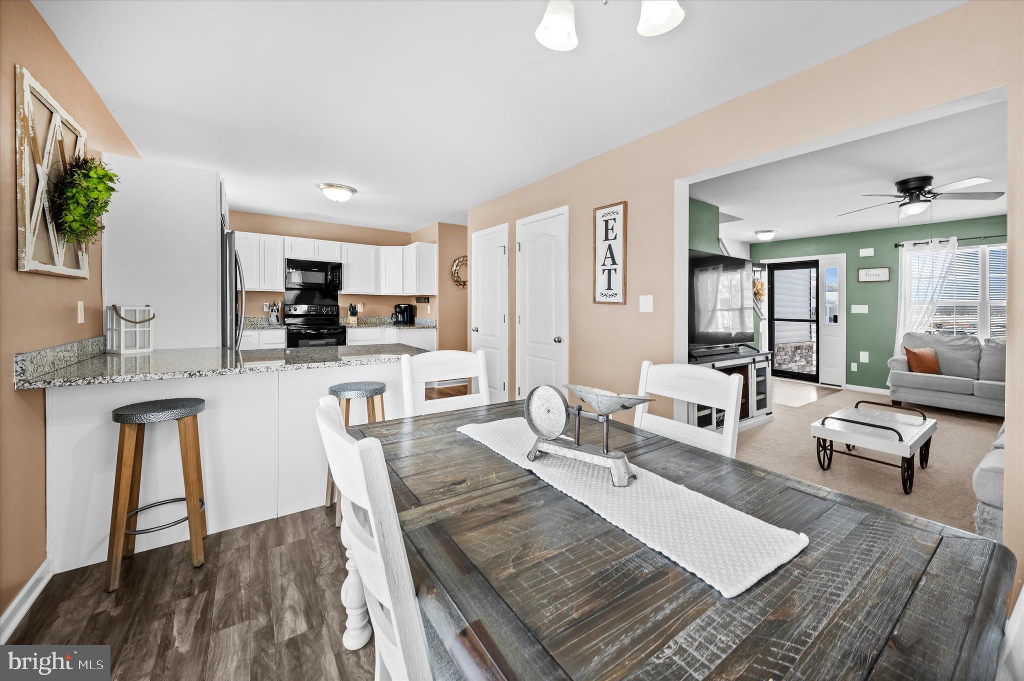 312 Doylestown Road Smyrna, DE 19977 - Photo 12 of 36 a living room with stainless steel appliances furniture a rug and a kitchen view