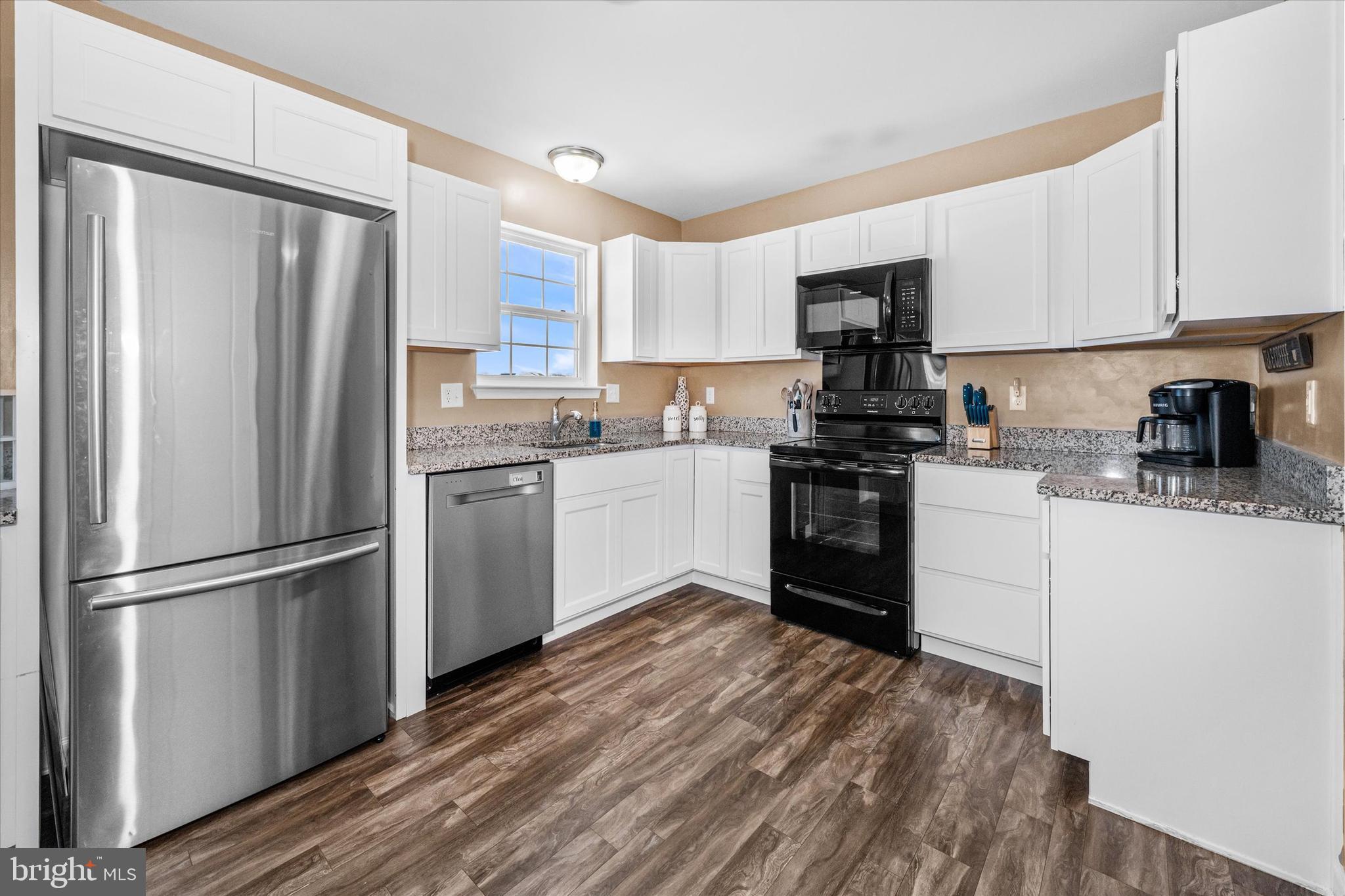 312 Doylestown Road Smyrna, DE 19977 - Photo 14 of 36 a kitchen with stainless steel appliances a refrigerator sink and cabinets