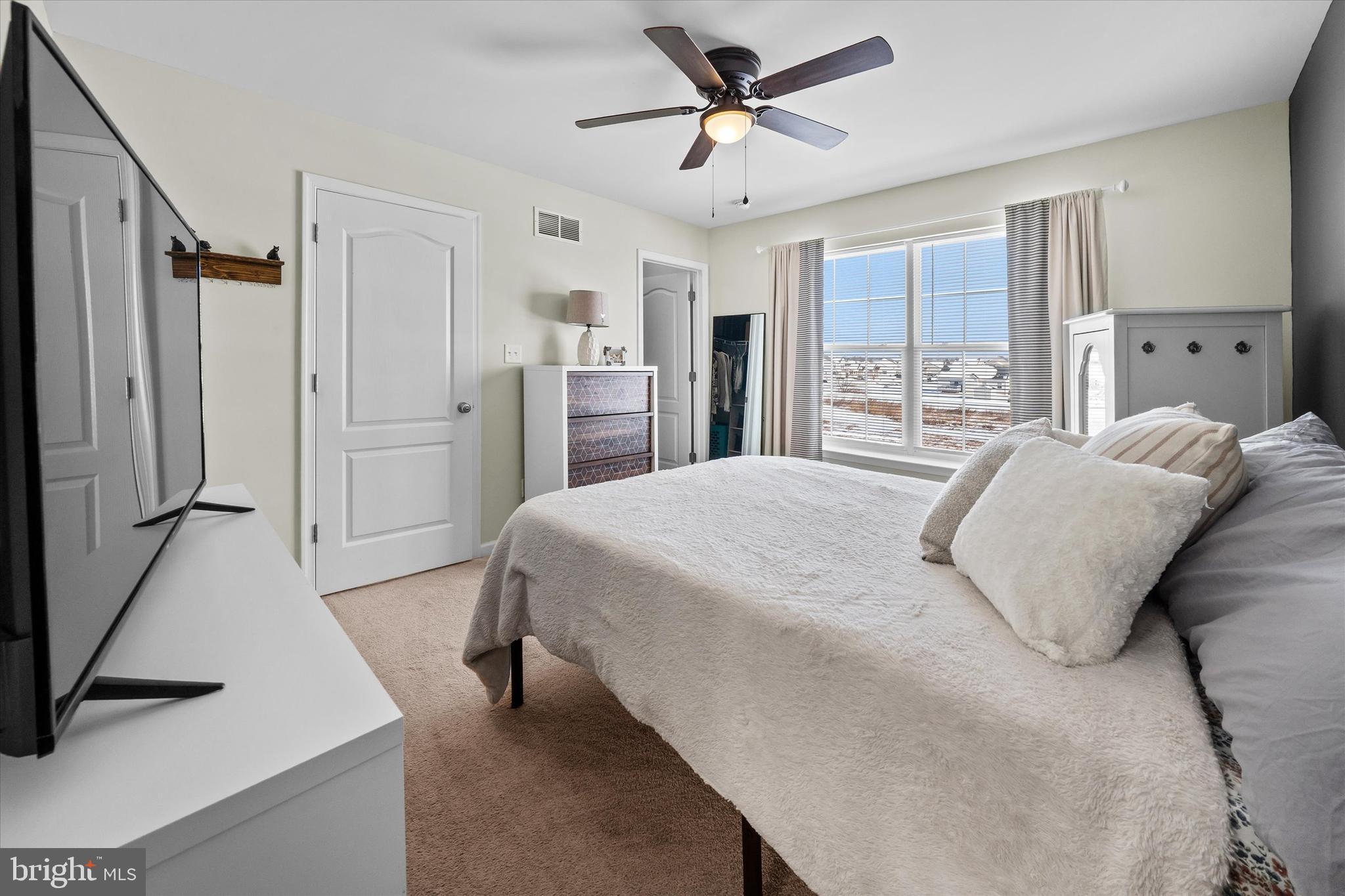 312 Doylestown Road Smyrna, DE 19977 - Photo 22 of 36 a spacious bedroom with a bed and a chandelier