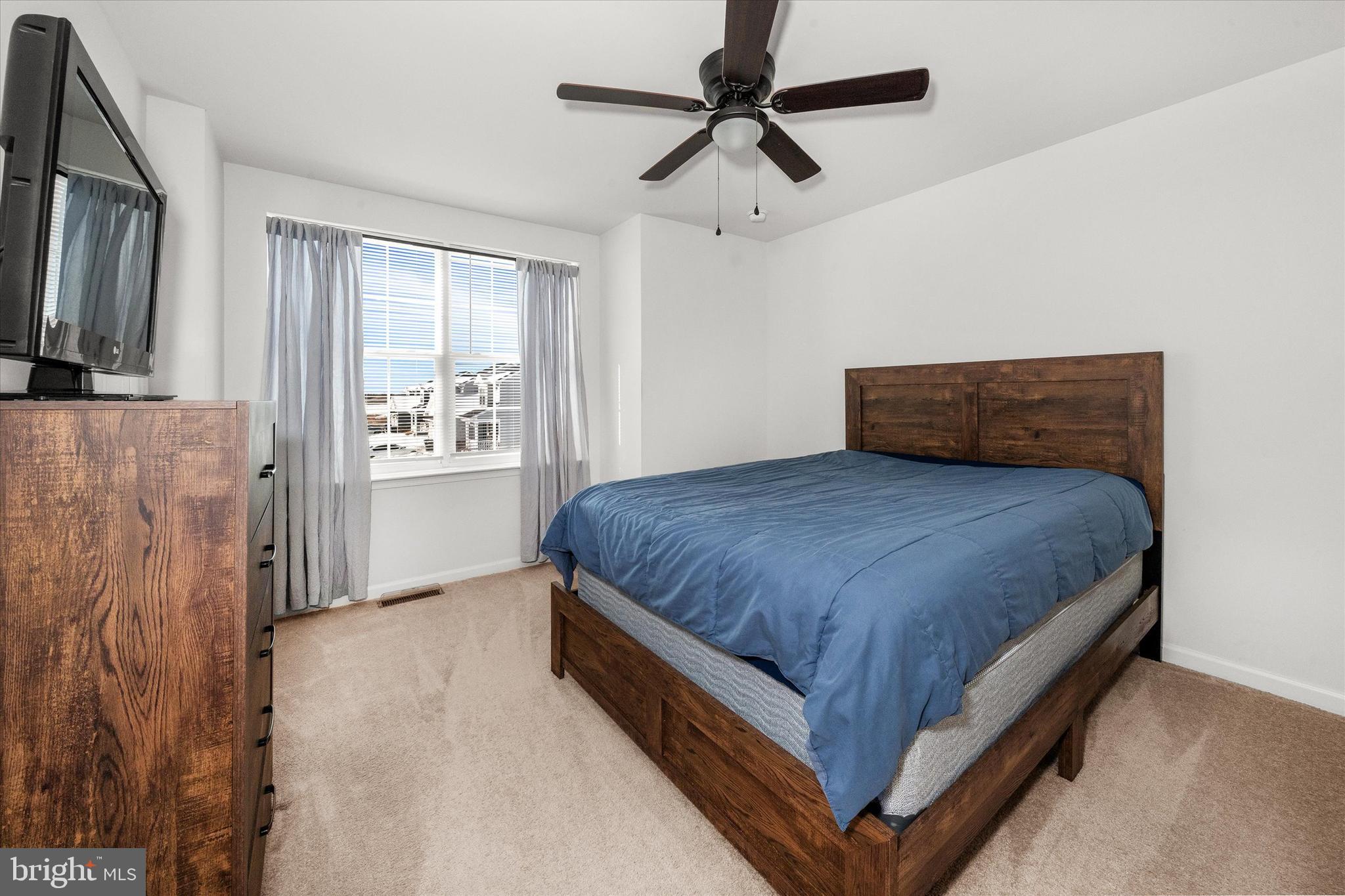312 Doylestown Road Smyrna, DE 19977 - Photo 25 of 36 a spacious bedroom with a bed and a chandelier