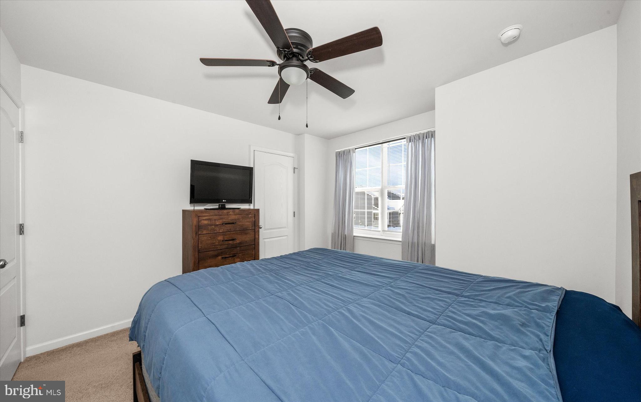 312 Doylestown Road Smyrna, DE 19977 - Photo 26 of 36 a bedroom with a bed and a flat screen tv