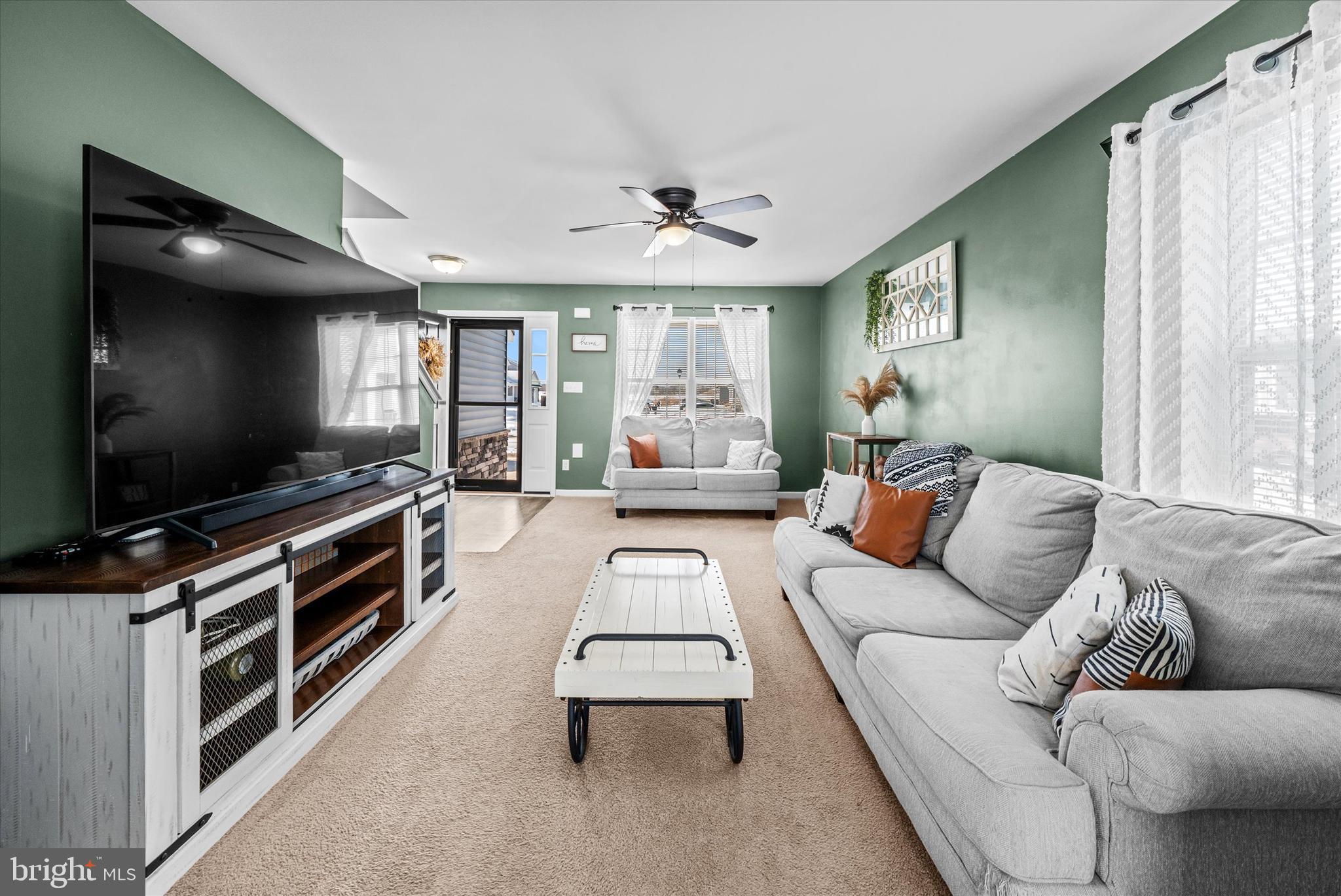 312 Doylestown Road Smyrna, DE 19977 - Photo 9 of 36 a living room with furniture and a flat screen tv