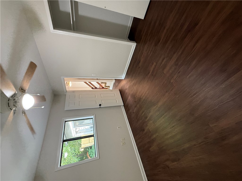 125 Maple Street, Unit 110 Pendleton, SC 29670 - Photo 16 of 18 Rich hardwood-style flooring extends through this airy room, highlighted by a window and ceiling fan.