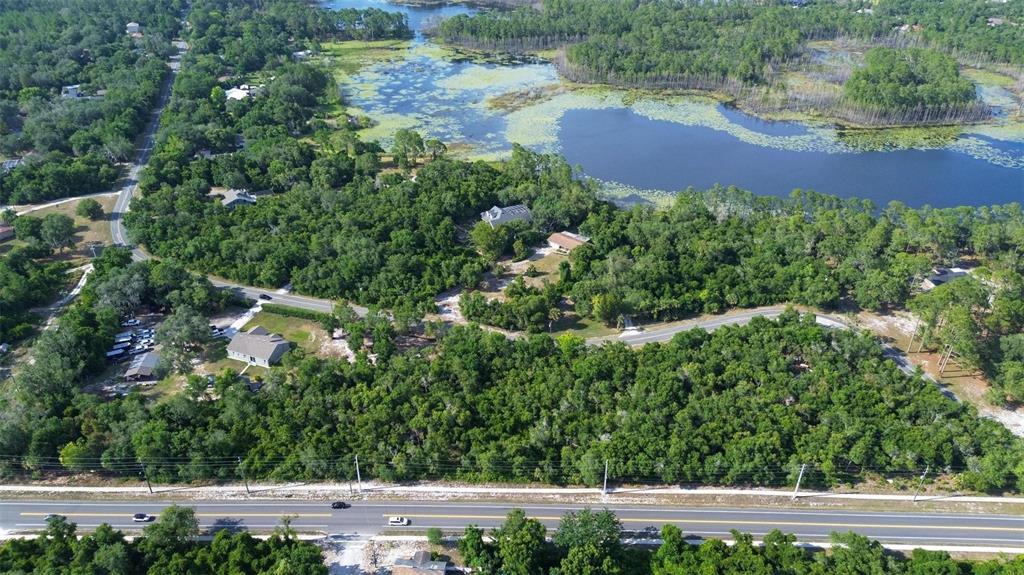 Doyle Road Deltona, FL 32725 - Photo 2 of 14 an aerial view of residential house with outdoor space and trees all around