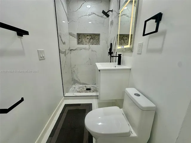 a bathroom with a toilet a sink and bathtub