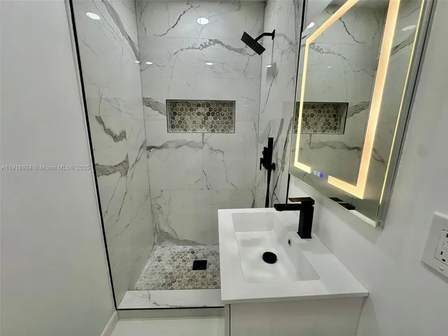 a bathroom with a sink and shower