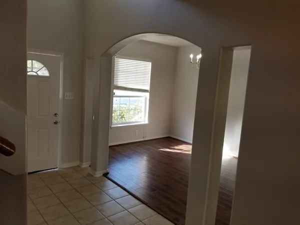 a kitchen with granite countertop a sink a stove and cabinets