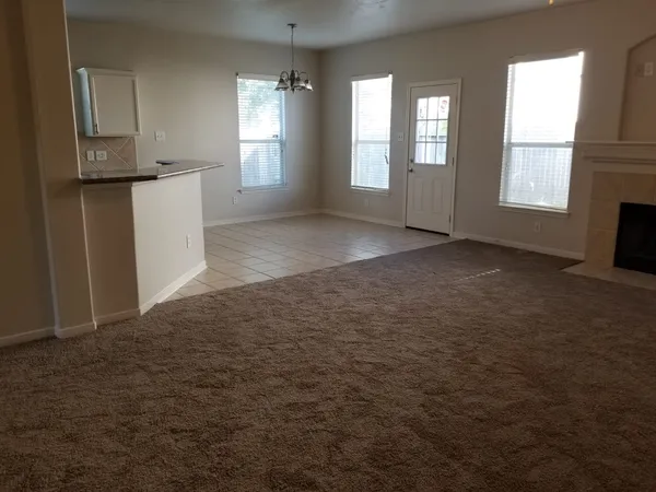 a kitchen with granite countertop a stove a sink and a window