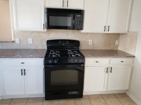 a white toilet sitting next to a white wall