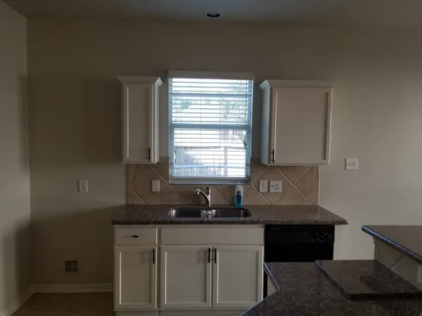 a view of a room with a wooden floor and a window