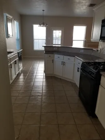 a view of empty room with stairs and door