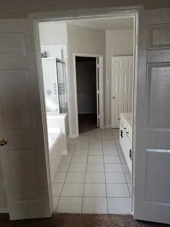 an empty room with closet and a bathroom