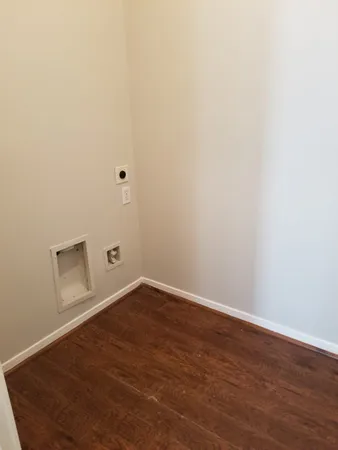 an empty room with windows and fireplace