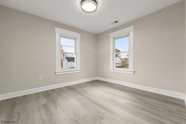 a bedroom with a bed couch and window