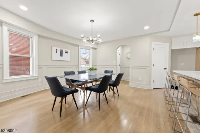 a view of a dining room with furniture and chandelier
