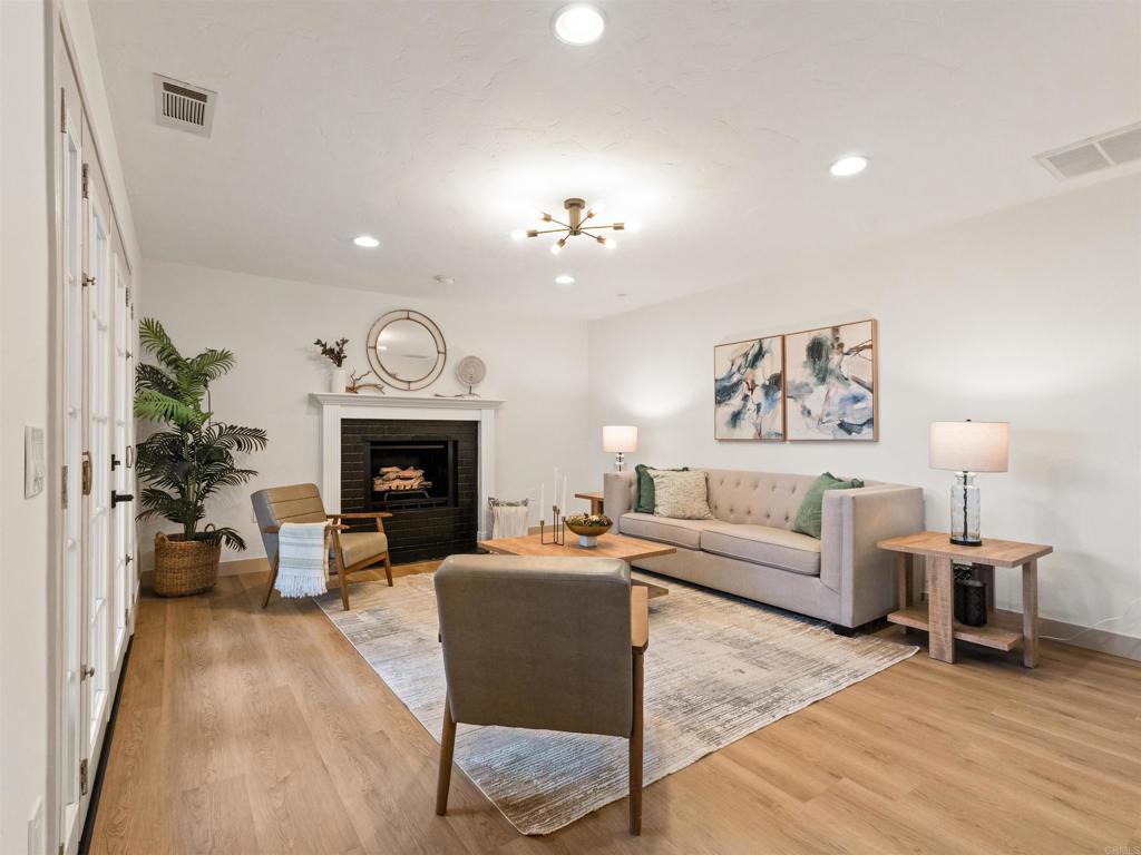 13737 Temple Street Poway, CA 92064 - Photo 14 of 38 a living room with furniture a fireplace and a chandelier
