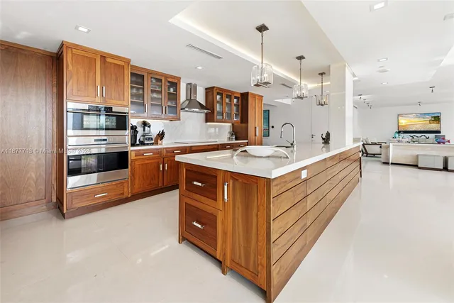 a view of a dining room with furniture and a chandelier